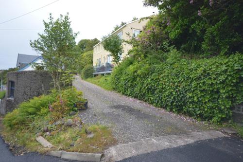 an empty road in front of a house at Ardura Apartment No 1 in Oban