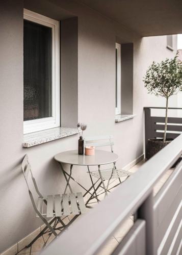 a balcony with a table and two chairs at apartments55 in Bressanone