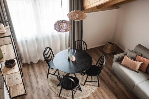 a dining room table and chairs in a living room at apartments55 in Bressanone