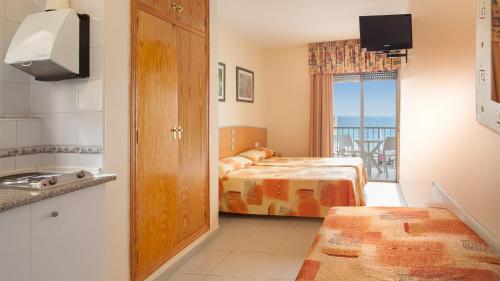 a bedroom with a bed and a view of the ocean at Estudios RH Sol in Benidorm