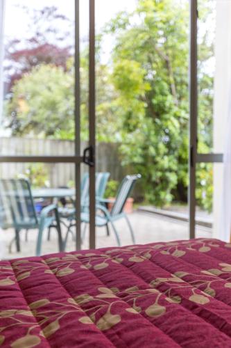 a bed with a purple blanket with hearts on it at Fernhill Motor Lodge in Lower Hutt
