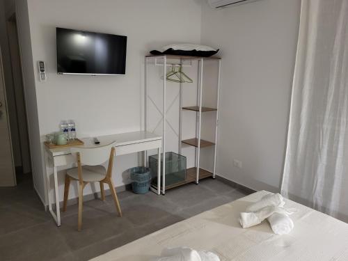 a bedroom with a desk and a chair and a bed at Casa Villaggio Pirandello in Agrigento