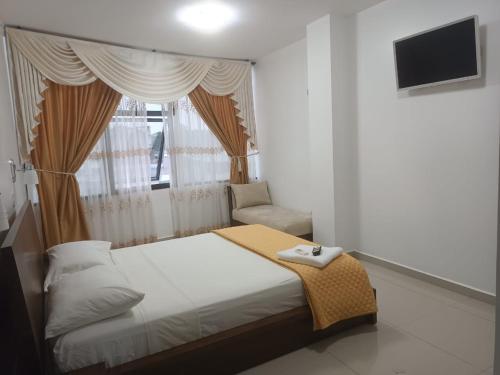 Postel nebo postele na pokoji v ubytování Hotel Quezada Hermanos