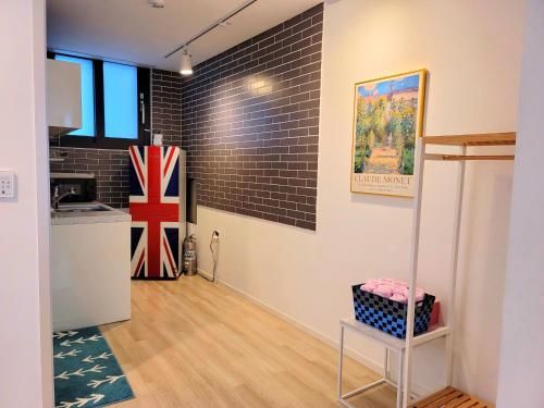 een kamer met een keuken en een bakstenen muur bij Gallery Family Hotel in Mokpo