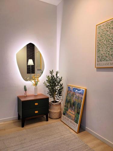 a living room with a table and a mirror at Gallery Family Hotel in Mokpo
