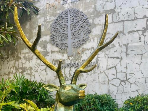 a bronze stag head with antlers in front of a wall at BC Summer Beach in Pran Buri