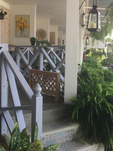 a porch with a white fence and a bench at BC Summer Beach in Pran Buri