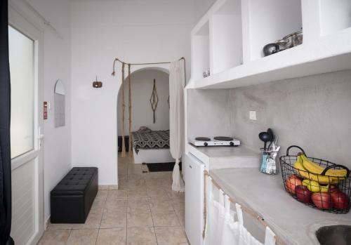 a kitchen with a sink and a counter with bananas on it at Eris Studios in Adamas