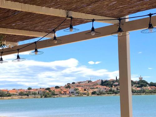 a group of lights hanging from a roof over a lake at Le Mas Palegry Chambres d'hôtes Perpignan in Perpignan
