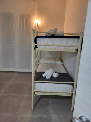 a couple of bunk beds with a stuffed animal on them at Casa Villaggio Pirandello in Agrigento