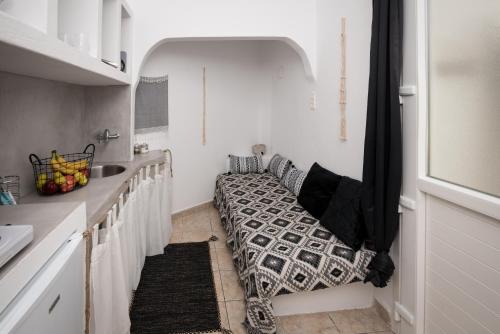 a kitchen with a bench in the corner of a room at Eris Studios in Adamas