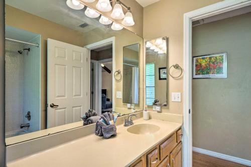 a bathroom with a sink and a large mirror at Fort Myers Home, Lanai and Private, Heated Pool in Fort Myers