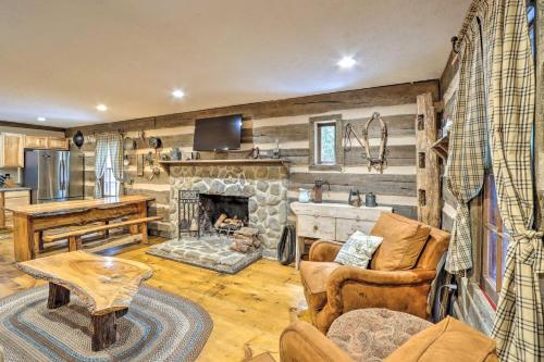 a living room with a stone fireplace in a house at Cozy Creekside Mountain Escape with Hot Tub! in Sautee Nacoochee