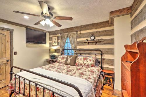 a bedroom with a bed and a ceiling fan at Cozy Creekside Mountain Escape with Hot Tub! in Sautee Nacoochee