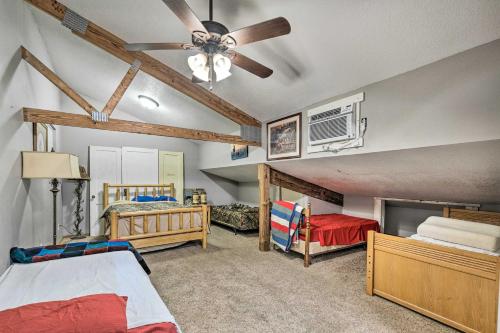 a bedroom with two beds and a ceiling fan at Massive Peck Home with Woods and Creek to Explore in Peck