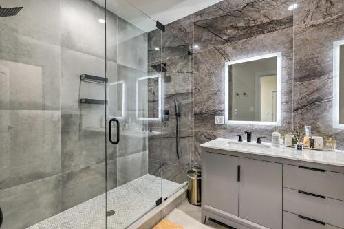 a bathroom with a glass shower and a sink at Luxury Smart Home 2 Miles to Downtown Atlanta! in Atlanta