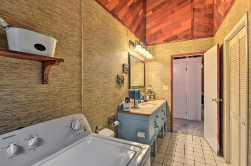 a bathroom with a blue sink and a tub at Step-Free Hawkins Bar Home Near Trinity River in Salyer
