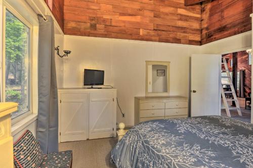 a bedroom with a bed and a tv on a wall at Step-Free Hawkins Bar Home Near Trinity River in Salyer