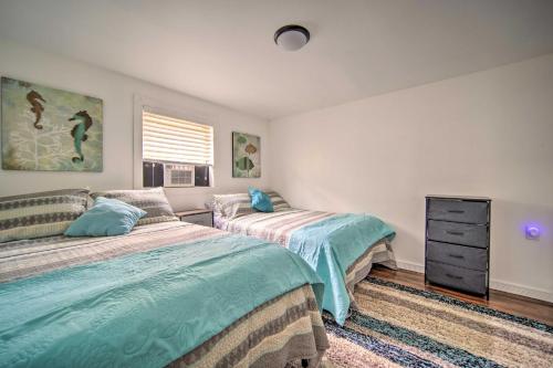 a bedroom with two beds and a dresser at Jamestown Retreat with Hot Tub - Walk to Lake! in Hartstown
