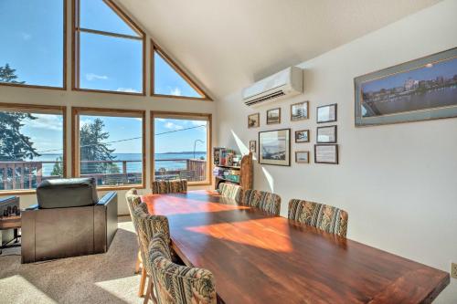 a dining room with a wooden table and chairs at Bay City Home with Gorgeous Bay Views From Deck in Bay City