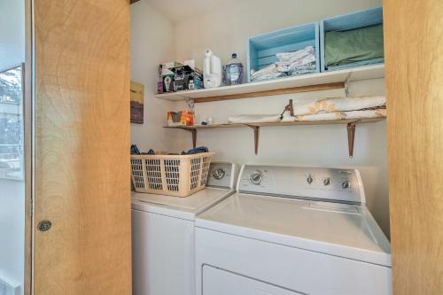 a laundry room with a washing machine and shelves at Bay City Home with Gorgeous Bay Views From Deck in Bay City