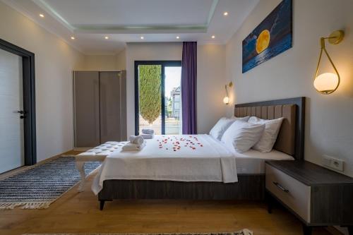 a bedroom with a large bed and a window at Tanrise City House in Fethiye