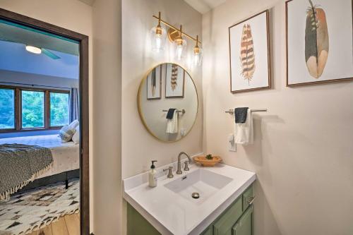 a bathroom with a sink and a mirror and a bed at Family-Friendly Galena Townhome with Community Pools in Galena