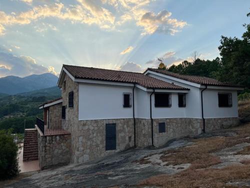 a house on a hill with a large white billboard at Casa Paco de Gredos in Arenas de San Pedro