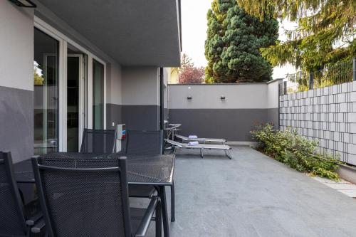 a patio with chairs and tables on a building at Wienerberg-Apartments in Vienna