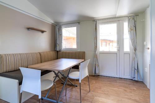 a dining room with a table and chairs at Camping Daino in Pietramurata
