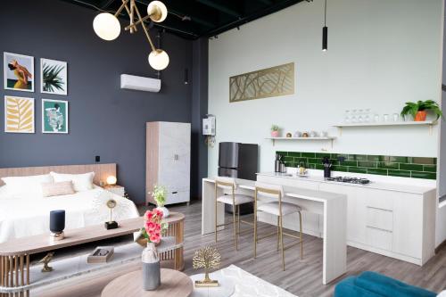 a living room with a bed and a kitchen at Royal Living Poblado in Medellín