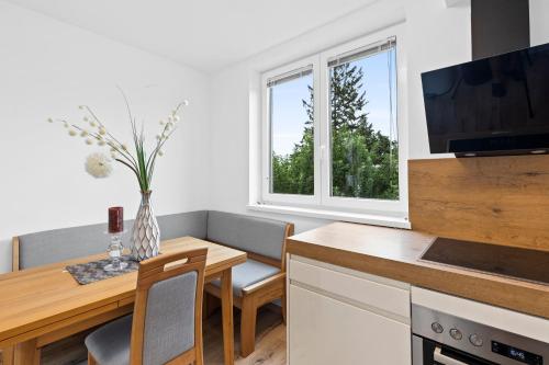 a kitchen and dining room with a table and a television at Wienerberg-Apartments in Vienna