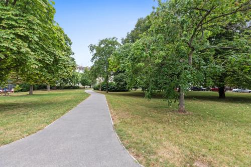 a walking path in a park with trees at Wienerberg-Apartments in Vienna