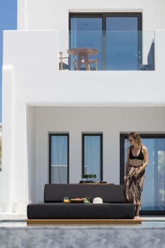 a woman standing on a couch in a living room at Milestones Naxos in Naxos Chora