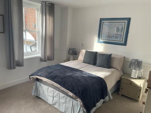 a bedroom with a bed and a window at The Crown Fakenham in Fakenham
