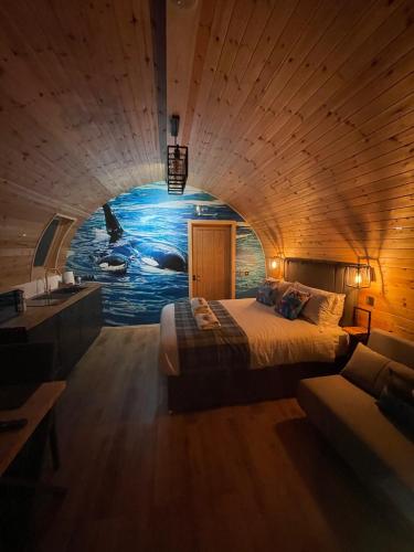 ケイスにある4 Sinclair bay lodgesのベッドルーム(ベッド1台付)とイルカの絵画