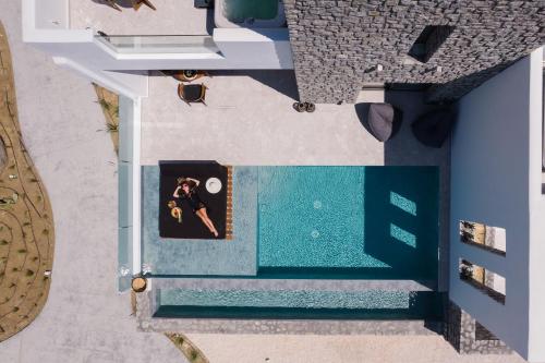 an overhead view of a swimming pool with a couple at Milestones Naxos in Naxos Chora