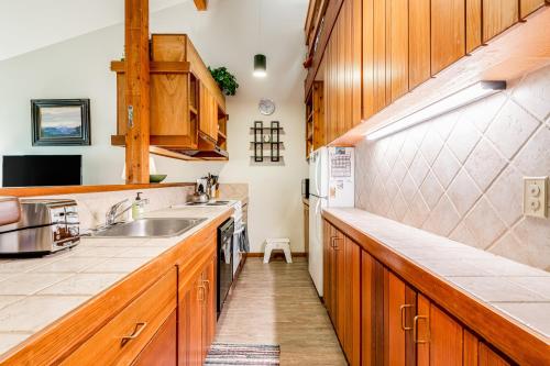 a kitchen with wooden cabinets and a sink at Lake Creek 1323 in Wilson