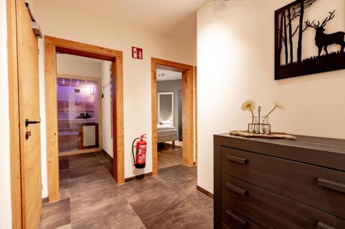 a living room with a dresser and a fire hydrant at Haus am Bach in Kaprun