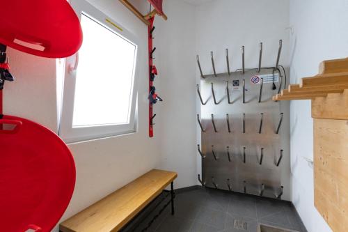 a room with a bench and a window and a door at Haus am Bach in Kaprun