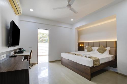 a bedroom with a large bed and a desk at StayBird - AERITH STUDIOS, Exclusive Residences, Kharadi in Pune