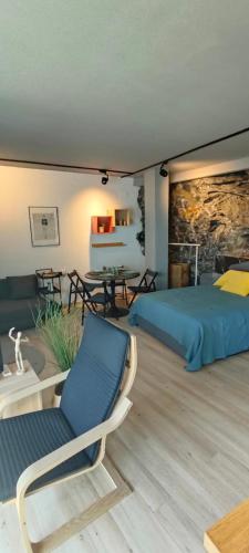a bedroom with a bed and a table and chairs at Victoria loft in Castell de Ferro