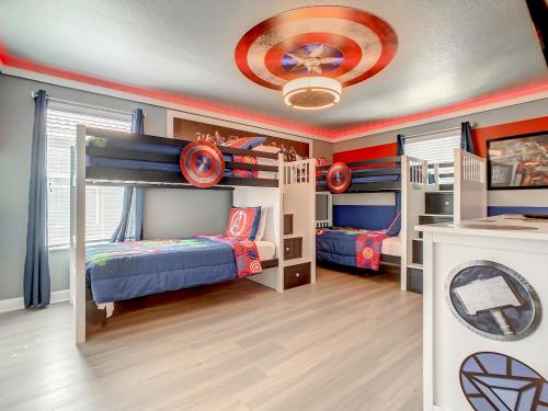 a kids room with two bunk beds and a ceiling at Marvelous Magical House: Amazing Themes and Pool, 5mi Disney in Kissimmee