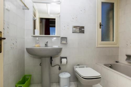 a bathroom with a sink and a toilet and a tub at Villa Orion - Peaceful Retreat Home West of Chania in Kipárissos