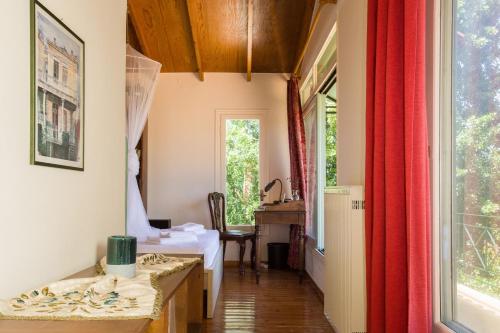 a room with two beds and a desk and a window at Villa Orion - Peaceful Retreat Home West of Chania in Kipárissos