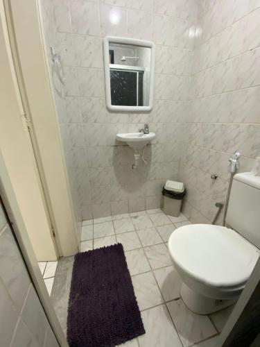 a bathroom with a toilet and a sink at Center 1 Hotel in Fortaleza