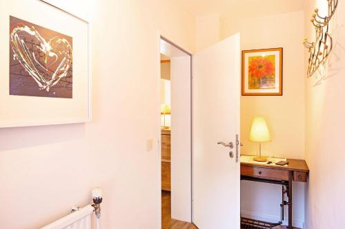 a hallway with a door leading into a room with a desk at Hygge in List