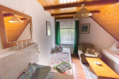 a bathroom with a sink and a mirror and a couch at Pension Zum Taucher in Gosen