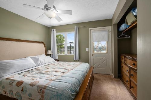 a bedroom with a bed and a ceiling fan at Waterfront Suite centrally located w/ private dock in Newaygo
