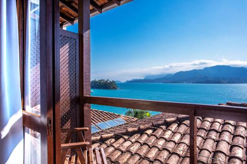 a view of the ocean from a house balcony at Barra do Piuva Porto Hotel in Ilhabela